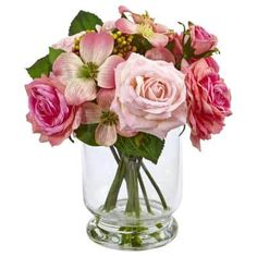 a vase filled with pink flowers on top of a table