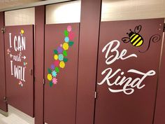 the bathroom stalls have been decorated with flowers and bee sayings on each stall door