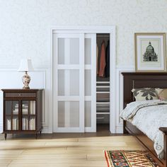 a bedroom with white walls and wooden floors