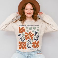 Step into the world of Jane Austen with this adorable feminist abstract wild flowers crewneck! Perfect for any cottagecore loving, Obstinate, Headstrong Girl! * Q U I C K * F A C T S * ✺ 50% cotton, 50% polyester ✺ Classic fit ✺ 1x1 athletic rib knit collar with spandex ✺ Inside out and wash and dry normally (on cool for best results). Do not iron decoration. ✺ Printed using DTG Direct to Garment printing.  ✺ Colors may vary due to computer monitors and printing inks. ✺ While we offer several shirt colors some may have a better contrast with the design. Keep that in mind when choosing your color.  * S I Z I N G * ✺ Sizing is unisex so runs like men's, though not overly large ✺ Size guide and fit: Please see size charts in photos for guidance on sizing to ensure the best fit.  ✺ The best wa Relaxed Fit Sweatshirt With Funny Print For Spring, Spring Cotton Sweatshirt With Custom Print, Jane Austen Shirts, Feminist Sweatshirt, Flower Sweatshirt, Iron Decoration, Wild Flower, Pride And Prejudice, Computer Monitors