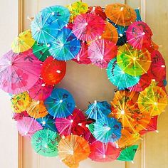 a wreath made out of umbrellas hanging on a door