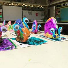 colorful paper cut out animals sitting on top of a table