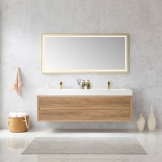 a bathroom with a large mirror above the sink and two vases on the floor