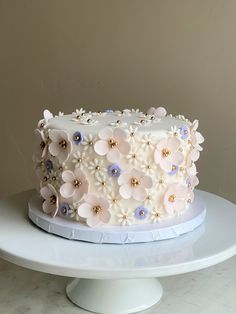 a large white cake with flowers on it