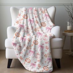 a white chair with a pink and orange blanket on it