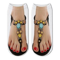 a woman's feet wearing sandals with beads and stones on the toes, in front of a white background