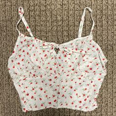 Nwot. Crop Floral Cami Top With Adjustable Straps. Ties In Front. Shirring Elastic On The Back For A Close Fit. Perfect For Summer Or Vacation. 100% Rayon. Size S. Measurements Taken Laying Flat: 11” Length From Front Top 13” Across Front White Printed Casual Crop Top, Spring White Printed Crop Top, Cute Red Crop Top For Spring, Forever 21 Red Crop Top For Summer, Cute White Crop Top For Summer, Forever 21 Floral Print Crop Top For Vacation, Forever 21 Floral Print Cotton Crop Top, Forever 21 White Beach Crop Top, Forever 21 Floral Print Cotton Tops