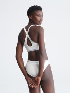 A Calvin Klein icon. This modern cotton bralette is the definition of effortless. Made with super soft and supple cotton stretch blended with modal for all day comfort. Designed with the original Calvin Klein logo band, this is a sporty look that feels sexy everyday. Pairs well with Modern Cotton Bikini , Modern Cotton Thong , and Modern Cotton High Waist Bikini .  Material: 53% Cotton, 35% Modal, 12% Elastane. Cotton Bralette, Padded Bralette, Cotton Pads, Sporty Look, Bra Women, Bralette, Calvin Klein, Sports Bra, Clothes For Women