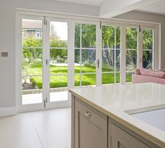 an open kitchen and living room with sliding glass doors leading to the back yard area