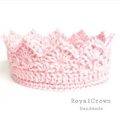 a pink crochet crown is shown on a white background