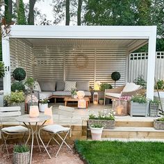 an outdoor living area with furniture and lighting