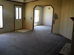 an empty room with two windows and no one in the house or someone is looking at it