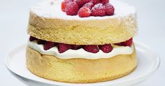 a cake on a plate with raspberries and icing