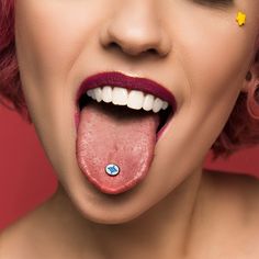 a woman with pink hair sticking out her tongue