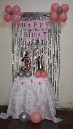 a birthday decoration with balloons and streamers