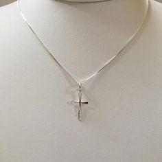 The hammered cross is made of sterling silver.  This simple cross pendant is offered in two sizes:  the smaller is just over 3/4" long and 3/8" across, the larger is just under 1" long and 5/8" wide.  The pendant comes on a .85 mm wide box link chain with a lobster claw. Please select what length chain you would prefer. The necklace will be shipped in a decorative cardboard jewelry box filled with an anti tarnish cotton. Sterling silver is a metal that can tarnish, storing it in the box in which White Gold Sterling Silver Cross Necklace, Spiritual Hammered Cross Necklace, Triquetra Pendant, Cross Necklace Simple, Cardboard Jewelry, Silver Cross Necklace, Simple Cross, Cardboard Jewelry Boxes, Small Crosses