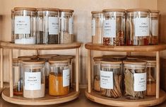 three wooden shelves filled with jars and spices