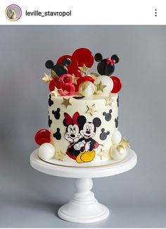 a mickey mouse cake with red and white decorations