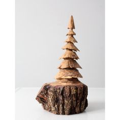 a small wooden tree sitting on top of a piece of wood