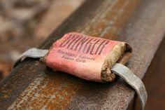 an old piece of luggage sitting on top of a rusted metal rail with the word junkgof written on it