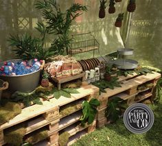 a table with pineapples and other items on it in a garden setting that is made out of wood pallets