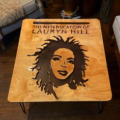 a wooden table with an image of a woman's face on it and the words, the miseducation of lauren hill