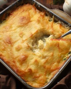 a casserole in a metal pan with a spoon sticking out of the top