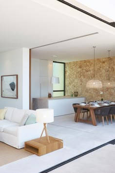 a living room filled with furniture next to a kitchen