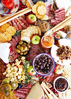 an assortment of meats and cheeses on a platter