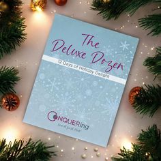 the deluxe dozen is days of holiday delight, with ornaments and lights around it on a white surface