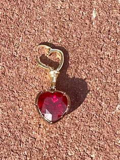 "Lower prices on our main website: https://discomarshmallow.myshopify.com/ This Georgian Victorian Ball Chain Pendant is set with a 5 carat heart shaped lab ruby (11 x 11 mm) in a Georgian cut-down down setting and is designed to hang from any of the ball chain necklaces. This pendant is a tribute to the intricate designs of the past, showcasing a delicate pendant that exudes timeless charm. The pendant is handcrafted in 18k blackened gold and 18k yellow gold, which is designed with versatility Luxury Heart Cut Ruby Jewelry, Yellow Gold Heart Cut Ruby Jewelry, Heart Cut Ruby Jewelry In Yellow Gold, Heart Cut Ruby Jewelry, Anniversary Ruby Jewelry With Heart Charm, Ruby Heart Charm Jewelry, Victorian Ball, Delicate Pendant, Ball Chain Necklace