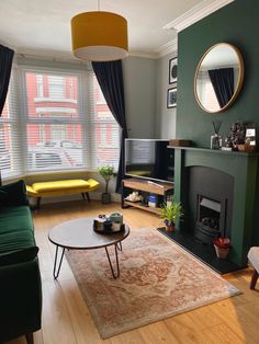 a living room filled with furniture and a fire place in front of a flat screen tv