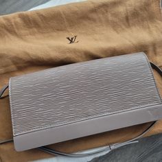 Louis Vuitton Honfleur Lilas Epi Leather Pochette/Clutch *Rare To Find* This Bag Has Been Discounted And Is Only Able To Buy On A Pre-Owned Market. Model# M5273b Size: 8.75 Inch (L) X 4.50 Inch(H) Drop: Up To 9.50 Inch Overall, Good Condition. Small Peeling On Corners, And Brownish Marks Around Leather Stitching. These Are Glue Marks From Design Flaws. This Pochette Can Turn Into A Clutch By Removing A Strap. Adjustable Strap Length. Perfect For Casual To Dressy Outfits. I Wore It Once For A Wedding And Have Been In My Closet Too Long. *Match Bracelet On The Listing* Comes With A Tag And A Dust Bag. No Box. Any Questions, Please Leave Comments. Happy Shopping Leather Stitching, Dressy Outfits, A Wedding, Lilac, Happy Shopping, Dust Bag, Adjustable Straps, Bag Lady, Louis Vuitton