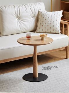 a living room with a couch, coffee table and other items on the floor in front of it