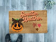 someone is sitting on the floor with their feet up in front of a door mat that says, sweeter weather