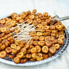 there is a platter full of fried food with skewers