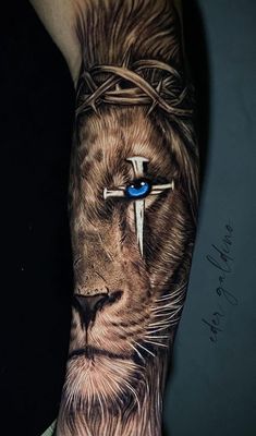 Jaw-Dropping Lion Tattoo Tattoo Sleeve Men Family, Lion Of God Tattoo, Best Leo Tattoo Designs, Cross With Lion Tattoo, Lion And Cross Tattoo For Women, Men’s Lion Tattoo, Christian Lion Tattoos For Men, Lion Crown Of Thorns Tattoo, Lion Arm Tattoo Men Sleeve