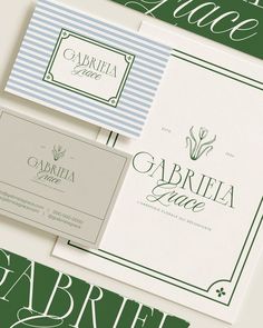 three different types of business cards with green and blue stripes on the front, one in white