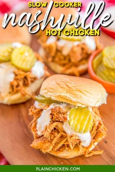 slow cooker nashvillee hot chicken on a cutting board with pickles and sauce