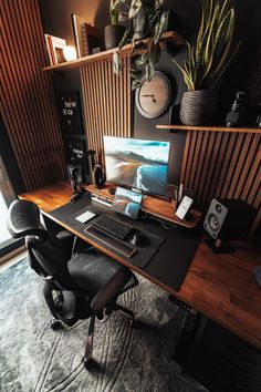 a desk with a monitor, keyboard and speakers