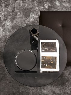 a black table with some silver items on it and a brown chair in the background