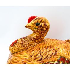 a yellow duck with a red hat on it's head is sitting in front of a white background