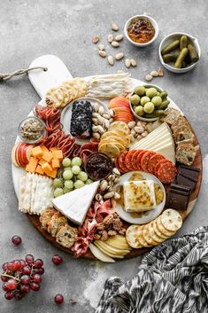 a platter filled with different types of cheeses and meats