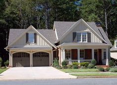 a large house with two garages in front of it