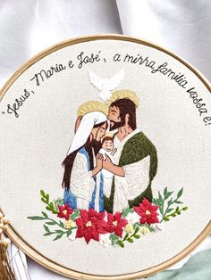 a cross stitched picture with the words jesus, mary and baby jesus on it