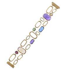 Marco Bicego Murano collection 18K yellow gold link bracelet, set with amethyst, citrine, peridot, topaz, tourmaline gemstones. DESIGNER: Marco Bicego MATERIAL: 18K Yellow Gold GEMSTONE: Spessartite garnet, Amethyst, Topaz, Peridot, Citrine CLARITY/COLOR: n/a MEASUREMENTS: Bracelet is 7" long x 1" wide MARKED/TESTED: Marco Bicego Made in Italy; Italian mark, 750 WEIGHT: 27.0 grams CONDITION: New PRODUCT ID: OG-1033 Modern Gold Multi-stone Gemstones, Modern Gold Bracelet With Multi-stone, Spessartite Garnet, Marco Bicego, Gold Link Bracelet, Gold Link, Strand Bracelet, Tourmaline Gemstone, Stunning Jewellery