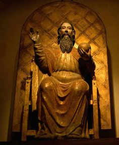 a statue of a man with a beard sitting on a chair