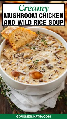 creamy mushroom chicken and wild rice soup in a white bowl with a piece of bread