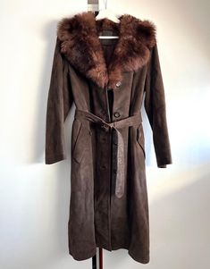 Vintage brown suede midi coat, fake fur collar, below the knee. Has two side pockets, button closure, lined, single breasted. Made in Sweden. Brand: Akta Getskinn Shows minimal wear, some natural imperfections on leather. Overall very good vintage condition No size tags, would fit sizes S. Please check measurements to insure a proper fit.  (You can compare this with something from your closet that fits you well.) Measured laying flat: 39 3/4" / 101 cm long 18 1/4" / 46.5 cm armpit to armpit 18 1 Vintage Suede Coat, Sheepskin Coat, Suede Coat, Vintage Suede, Fake Fur, Brown Belt, Suede Jacket, Fur Collar, Fur Collars