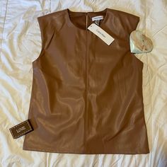 Brand Nwt Calvin Klein Brown Faux Leather Armless Shirt With Button Closure In The Back. Padded Shoulders Making This Great For Going Out, Work, And Causal Wear. *Please Note Stock Photo Is For Reference, The Item Is Brown Not Black Faux Leather Top For Work In Spring, Faux Leather Tops For Work In Spring, Faux Leather Tops For Spring Workwear, Womens Knit Tops, Faux Leather Top, Calvin Klein Shorts, Black Sleeveless Blouse, Sleeveless Knit Top, Calvin Klein Red